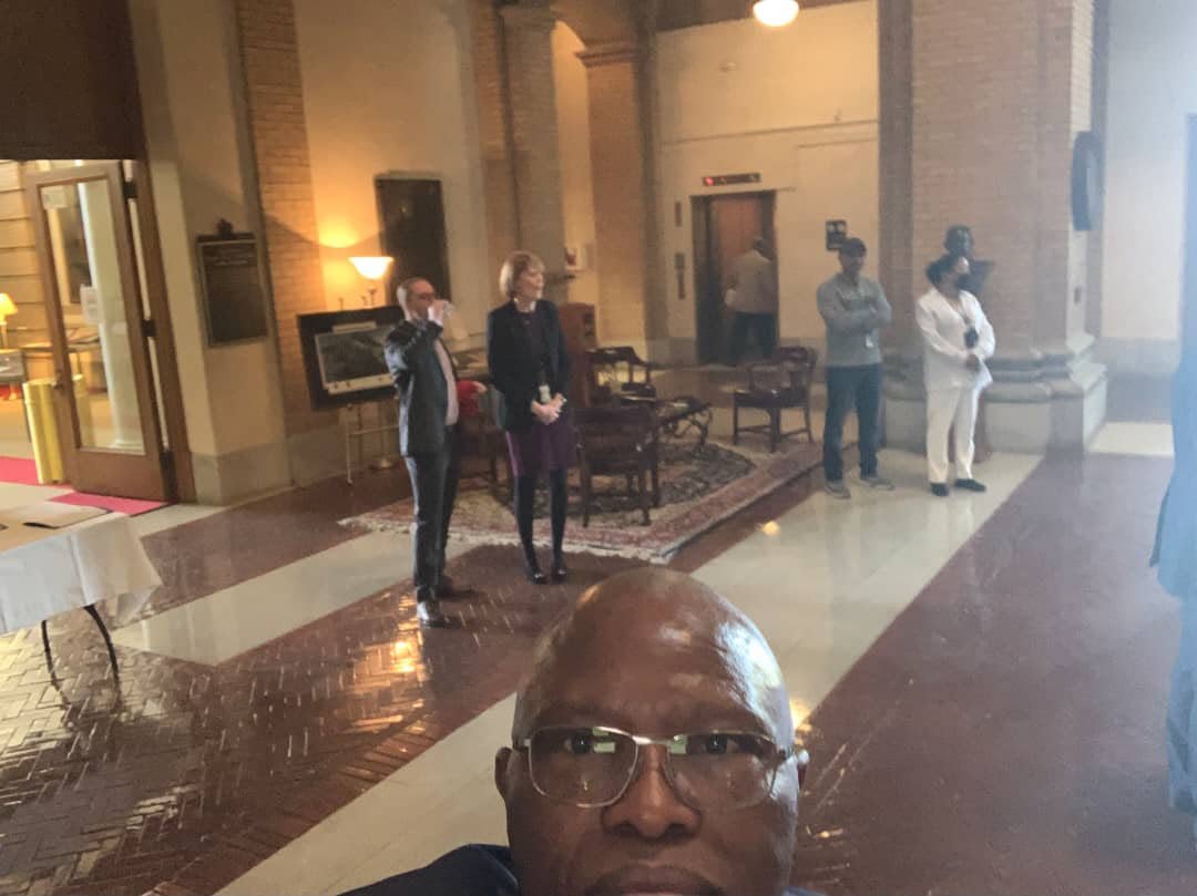 An indoor gathering seen from a selfie perspective