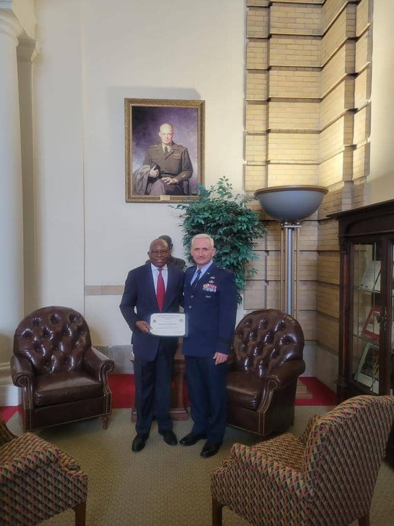 Two men standing together in a meeting room